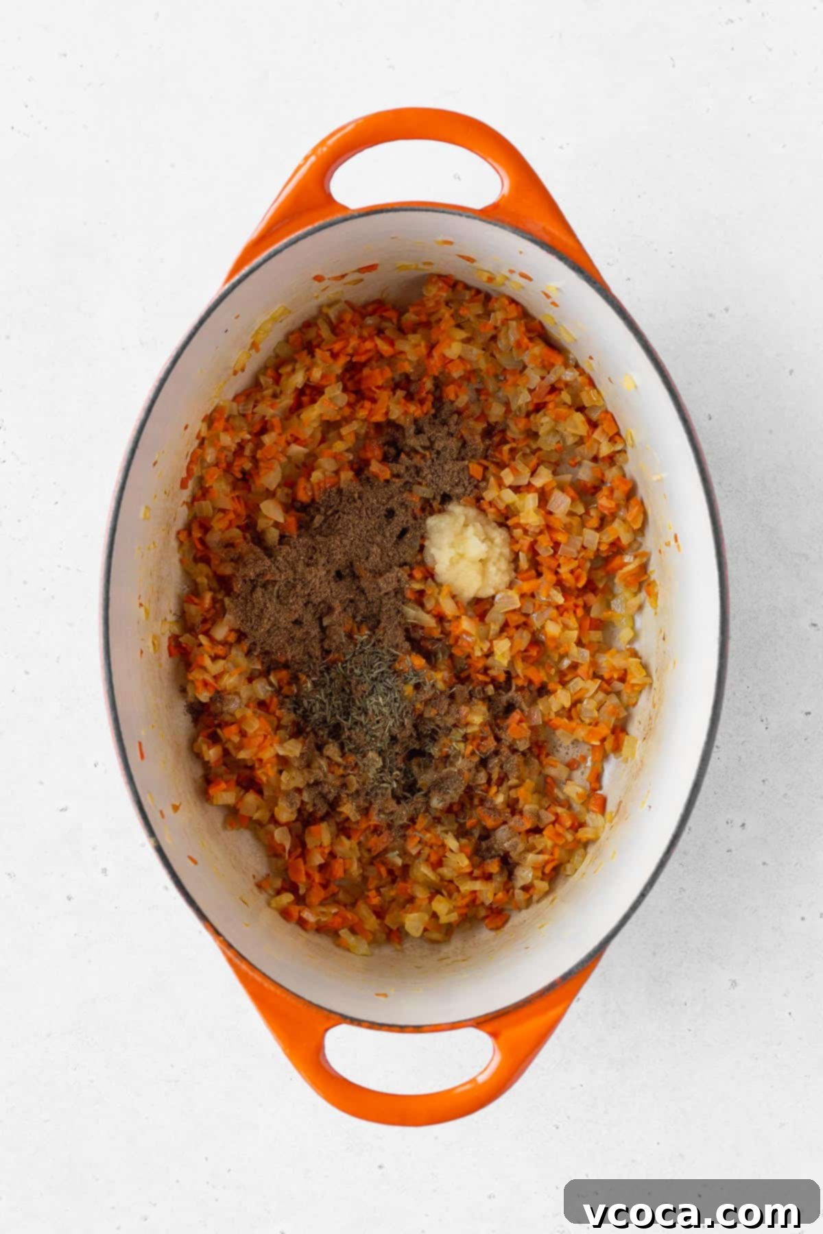 Garam masala, dried thyme, and grated garlic added to the pot.