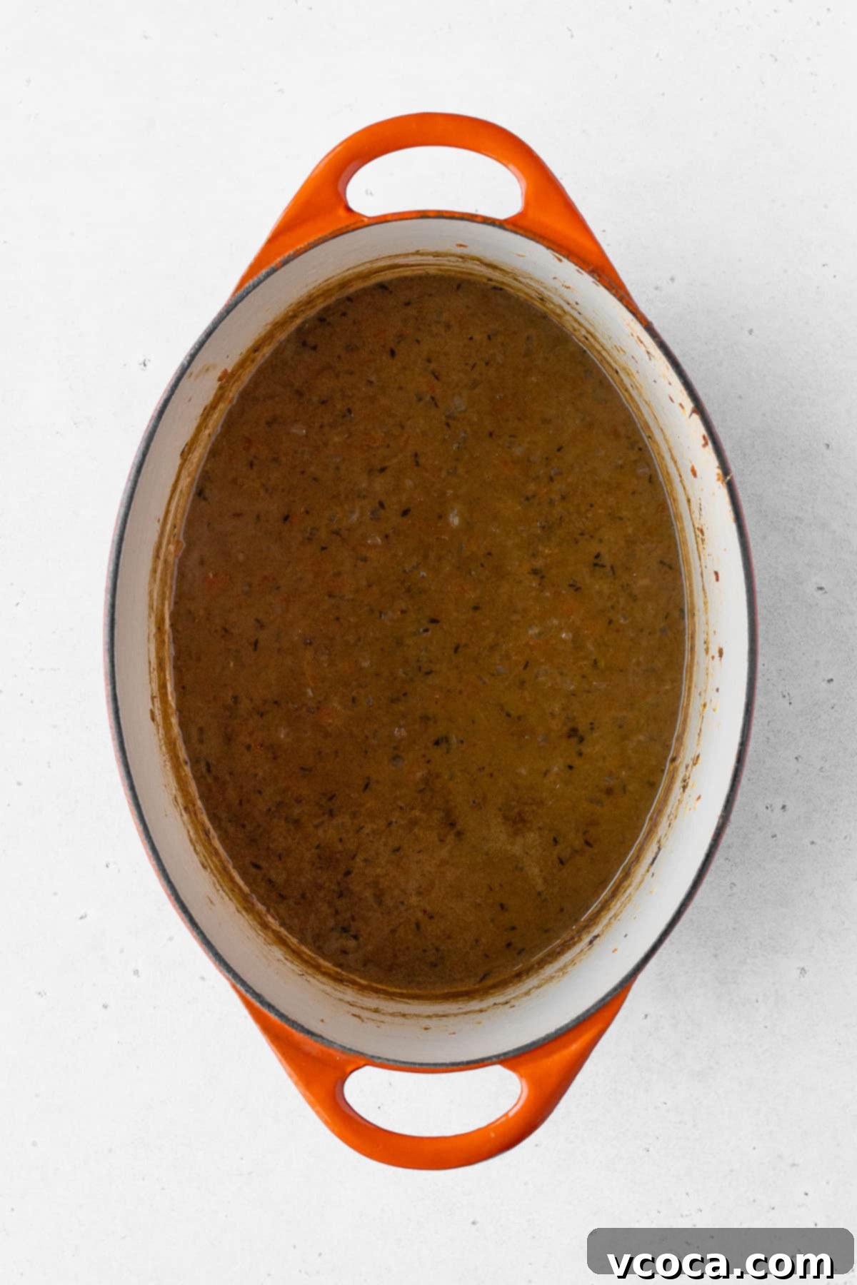 Vegan Japanese curry in a pot with orange handles.