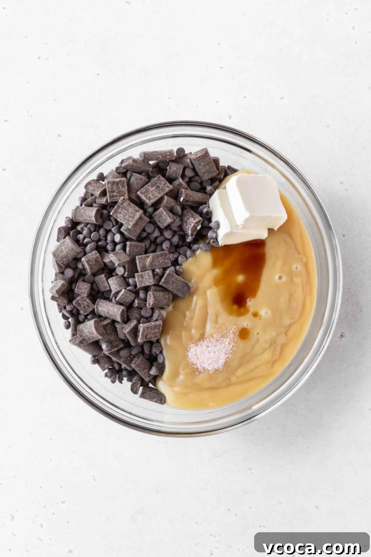 Plant-Based Fudge 5 Ingredients for dairy-free fudge added to clear glass bowl.