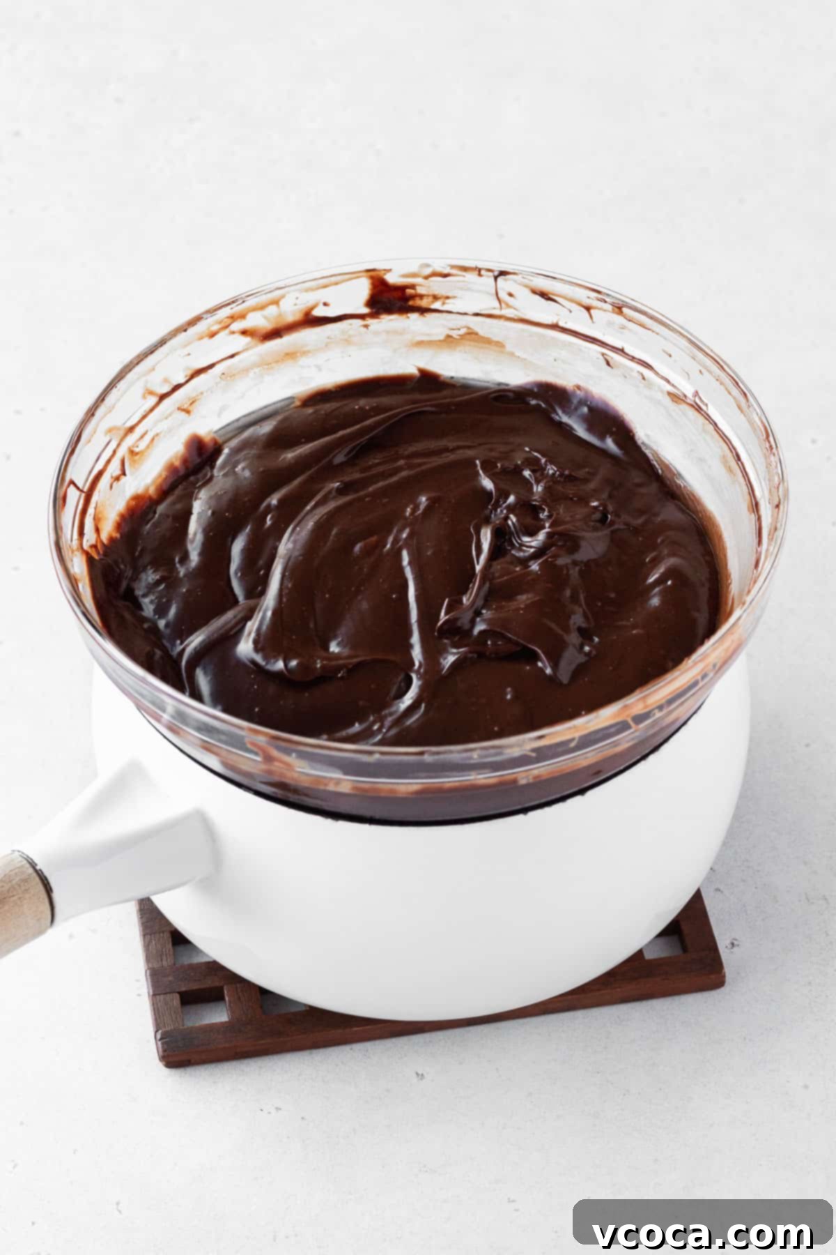 Plant-Based Fudge 6 Fudge ingredients in a bowl on top of a double boiler after melting and being mixed.