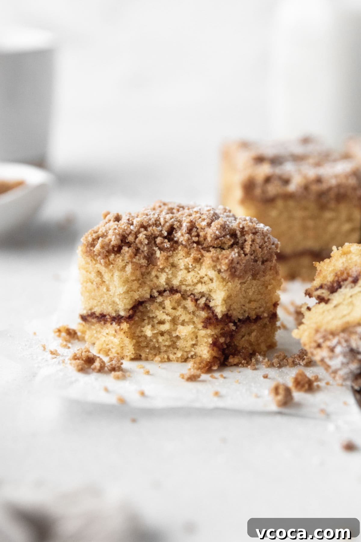 Deliciously Guilt-Free Coffee Cake 2 A square of gluten-free coffee cake with a bite taken out, showcasing the moist interior and crumbly topping.