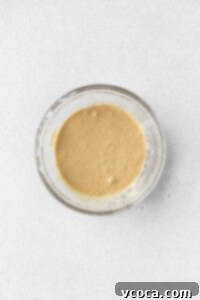 Wet ingredients for making gluten-free coffee cake mixed together in a bowl.