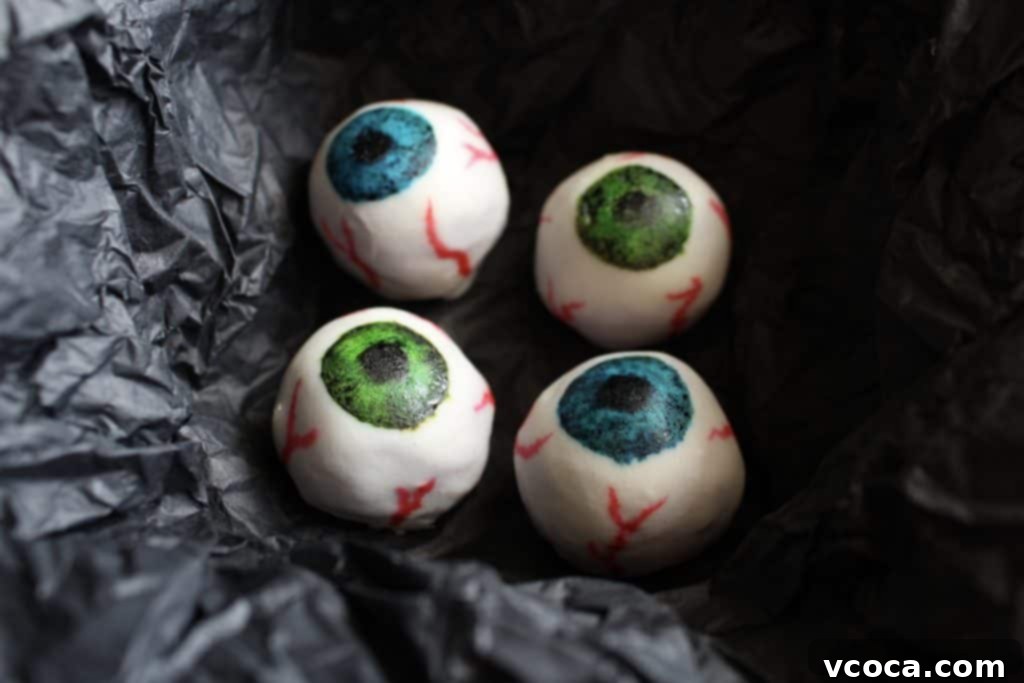 These Halloween white chocolate eyeballs have a surprise filling: purple sweet potato! A much healthier option for trick or treating kids on Halloween!  #Halloween #HappyHalloween #healthy #whitechocolate #chocolate #truffle #purple #black #sweetpotato #eyeball #eyeballs #trickortreat #kids