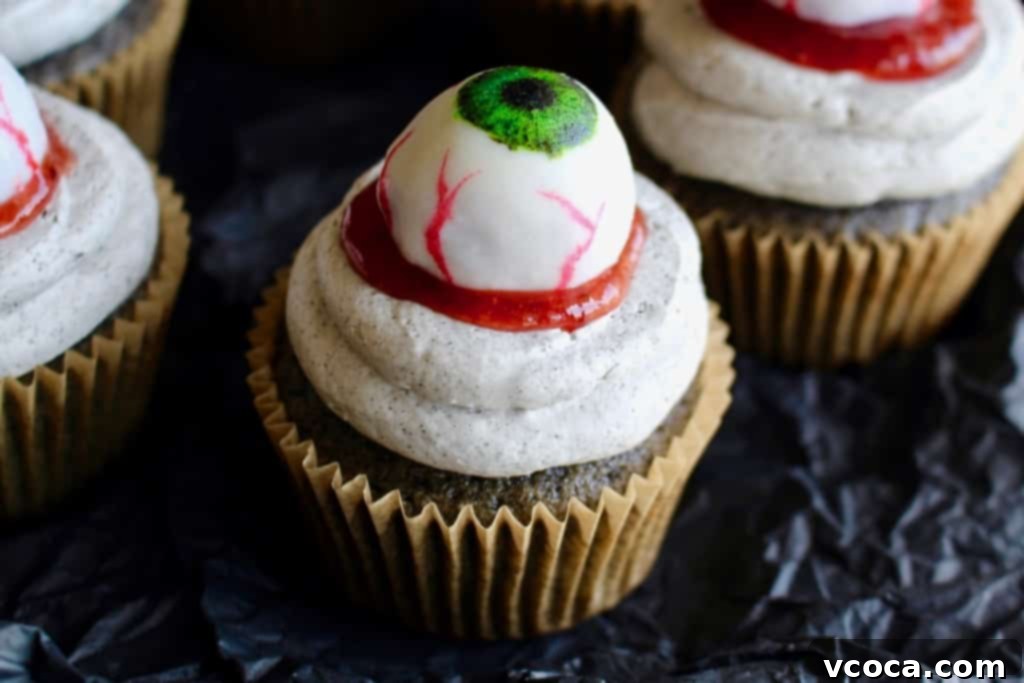 Spooky Black Sesame Eyeball Cupcakes 2 Halloween black sesame cupcakes are the perfect unique treat for an adult Halloween party! These Halloween eyeball cupcakes have a fluffy black sesame cake topped with black sesame buttercream frosting, topped with my Halloween white chocolate eyeballs! I added a spoonful of berry jam as fake blood, but I think mixing some black tahini with honey to make a spooky black goop would pair better in terms of taste.