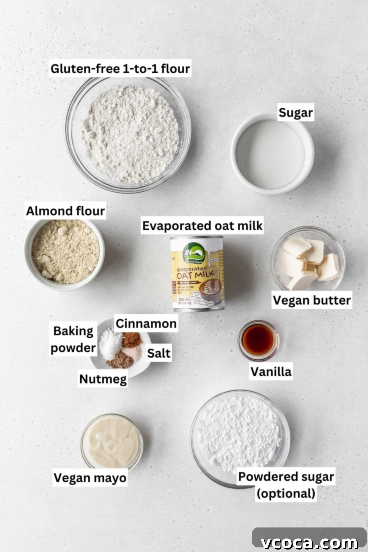 Wholesome Plant-Based Baked Donuts 4 Ingredients needed for making dairy free gluten free vegan baked donuts laid out on a white table with text overlay.