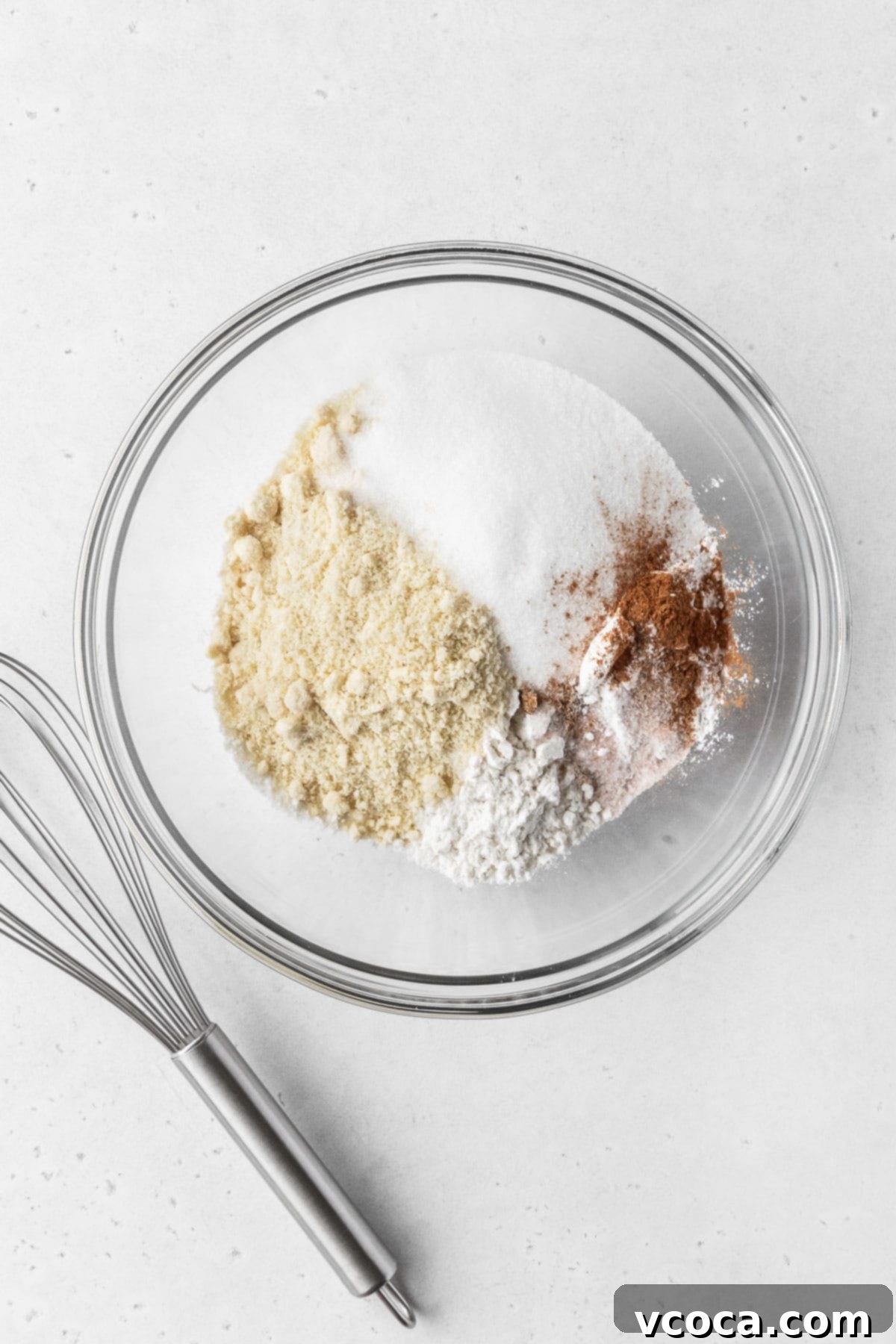 Wholesome Plant-Based Baked Donuts 5 Dry ingredients for making dairy free gluten free vegan baked donuts in a mixing bowl.