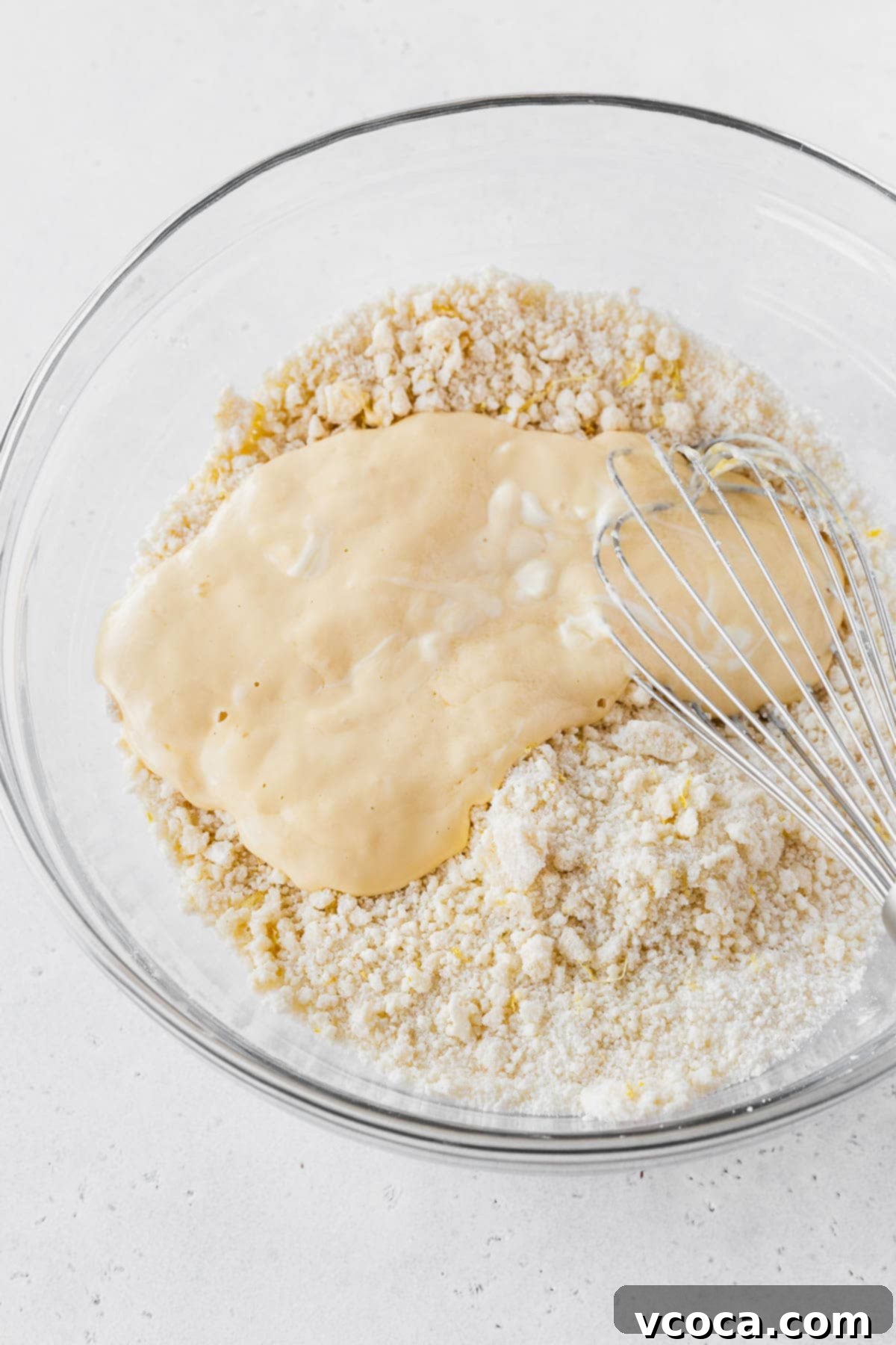 Luscious Lemon Curd Cake 15 Wet ingredients added to dry ingredients for the lemon layer cake recipe.