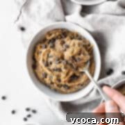 No-Bake Gluten-Free Cookie Dough 12 Square hero of vegan dairy-free edible cookie dough in a bowl with a hand taking a spoonful.