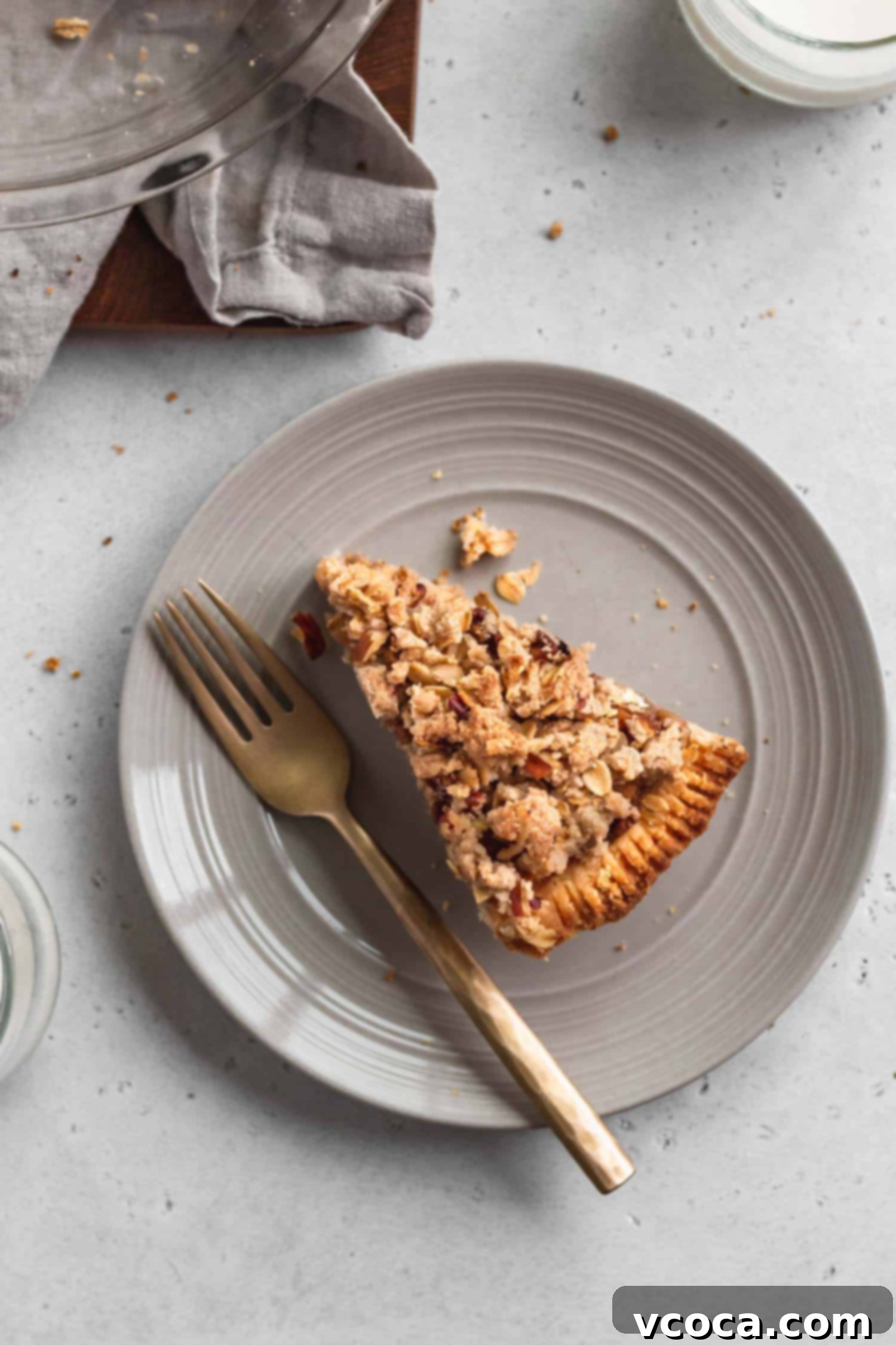 Gluten Free Dutch Apple Crumble Pie 4 A perfectly baked slice of gluten-free and dairy-free apple crumble pie on a plate, ready to be enjoyed