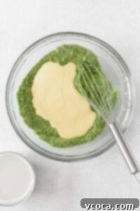 Wet ingredients being added to the dry matcha flour mixture.