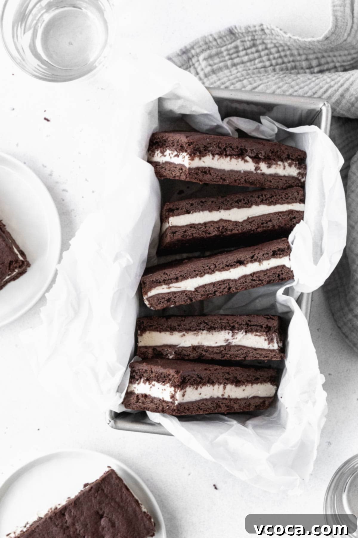 Guilt-Free Frozen Indulgence 15 Ice cream sandwich cookies in a parchment paper-lined loaf pan.
