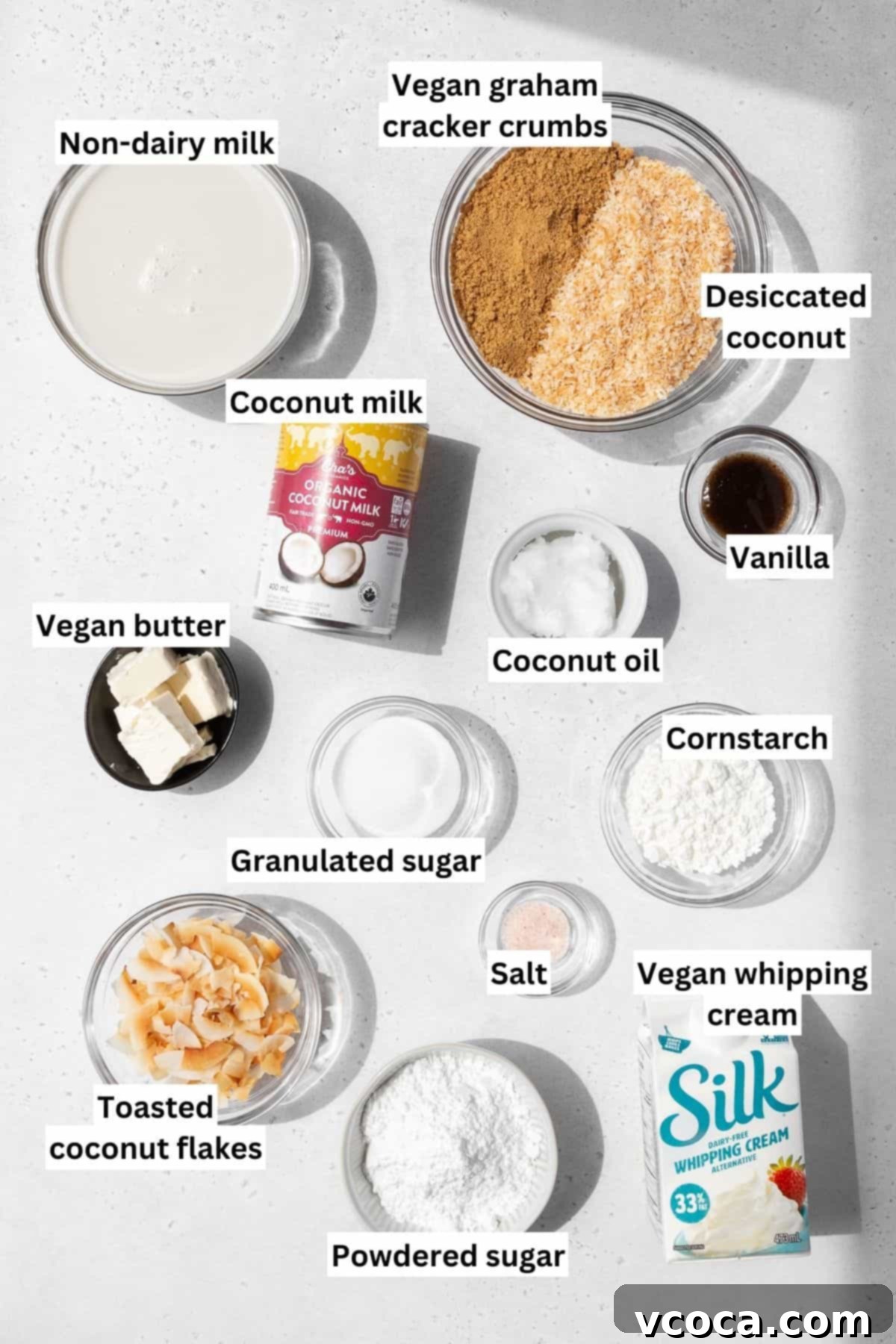 Divine Vegan Coconut Cream Pie Gluten Free 3 Overhead shot of ingredients needed to make vegan, gluten-free no-bake coconut cream pie measured out into bowls on a white table with text overlay.