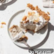 Divine Vegan Coconut Cream Pie Gluten Free 17 Square hero image of vegan no bake coconut cream pie on a white plate with a fork taking a bite out.
