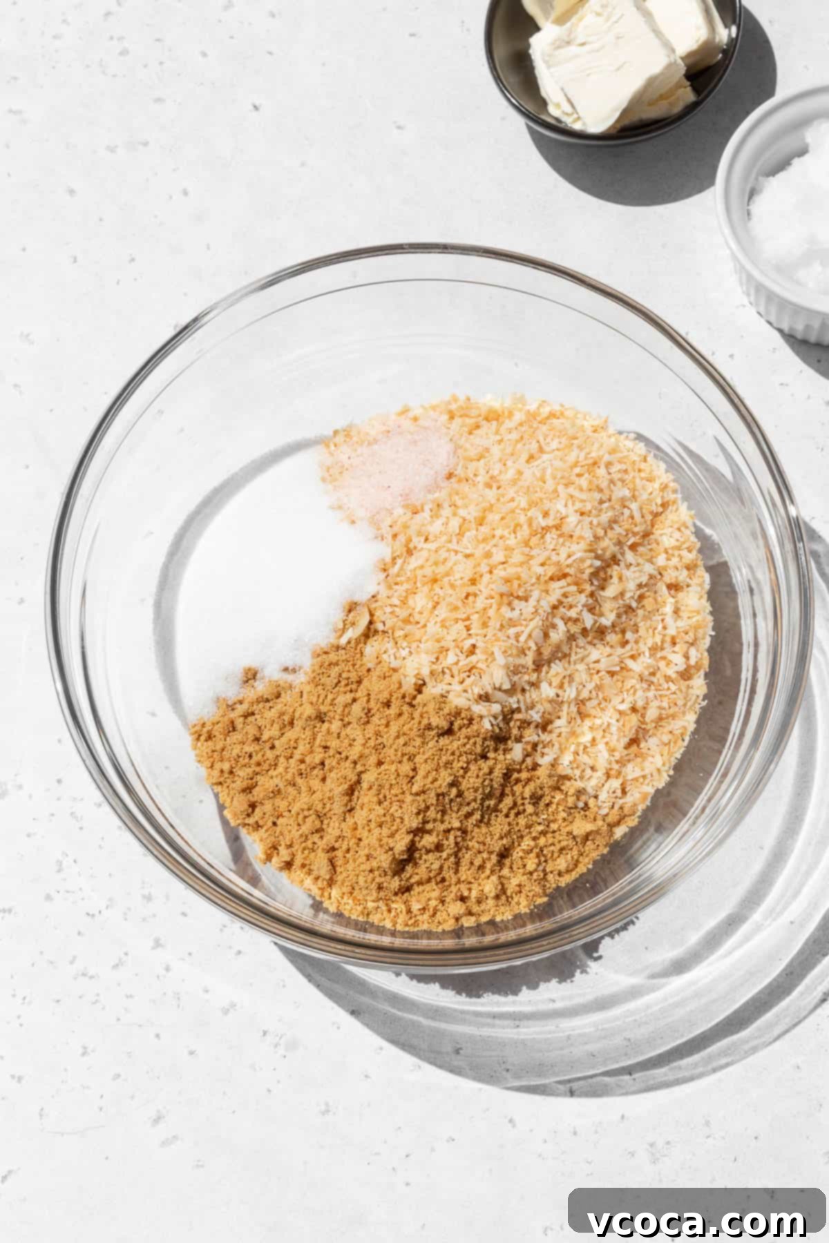 Divine Vegan Coconut Cream Pie Gluten Free 4 Dry ingredients for making gluten-free coconut graham cracker pie crust in a mixing bowl.