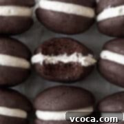 Gluten-Free Whoopie Pies 4 An up-close shot of a gluten-free whoopie pie with a bite taken out of it.