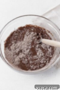 Stirring the dry gluten-free whoopie pie ingredients into the wet ingredients.