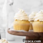 Velvety Vegan Buttercream 10 Square hero image of vegan vanilla cupcakes topped with a swirl of dairy-free vanilla buttercream.