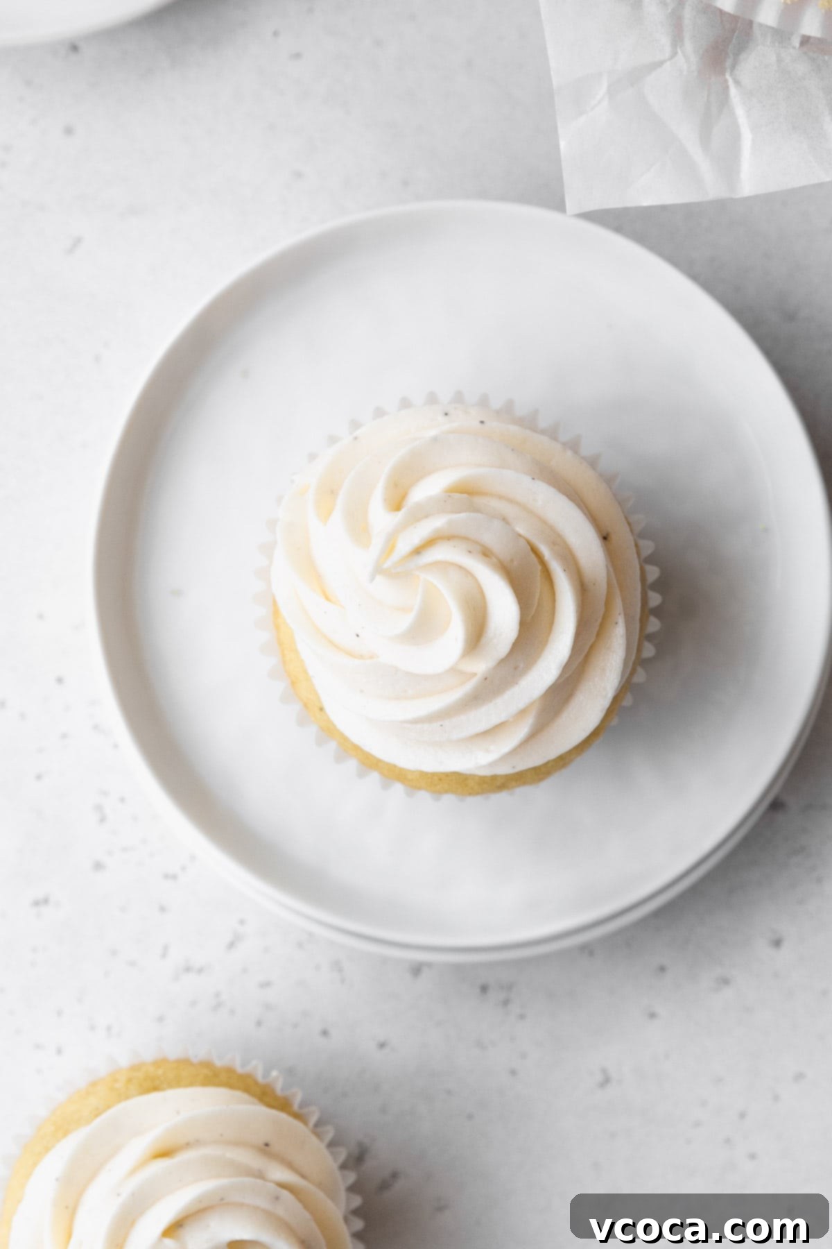 Velvety Vegan Buttercream 9 Overhead shot of a vanilla cupcake topped with vegan vanilla buttercream frosting.