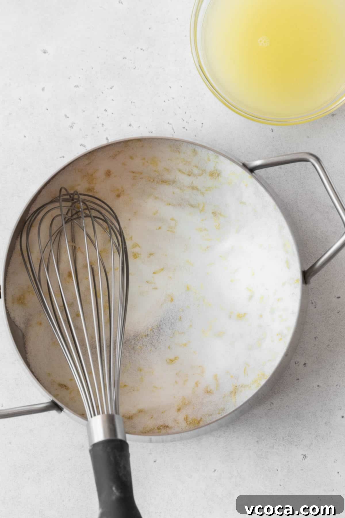 Bright and Zesty Dairy Free Lemon Bars 11 Whisked sugar and lemon zest in a saucepan on the counter.