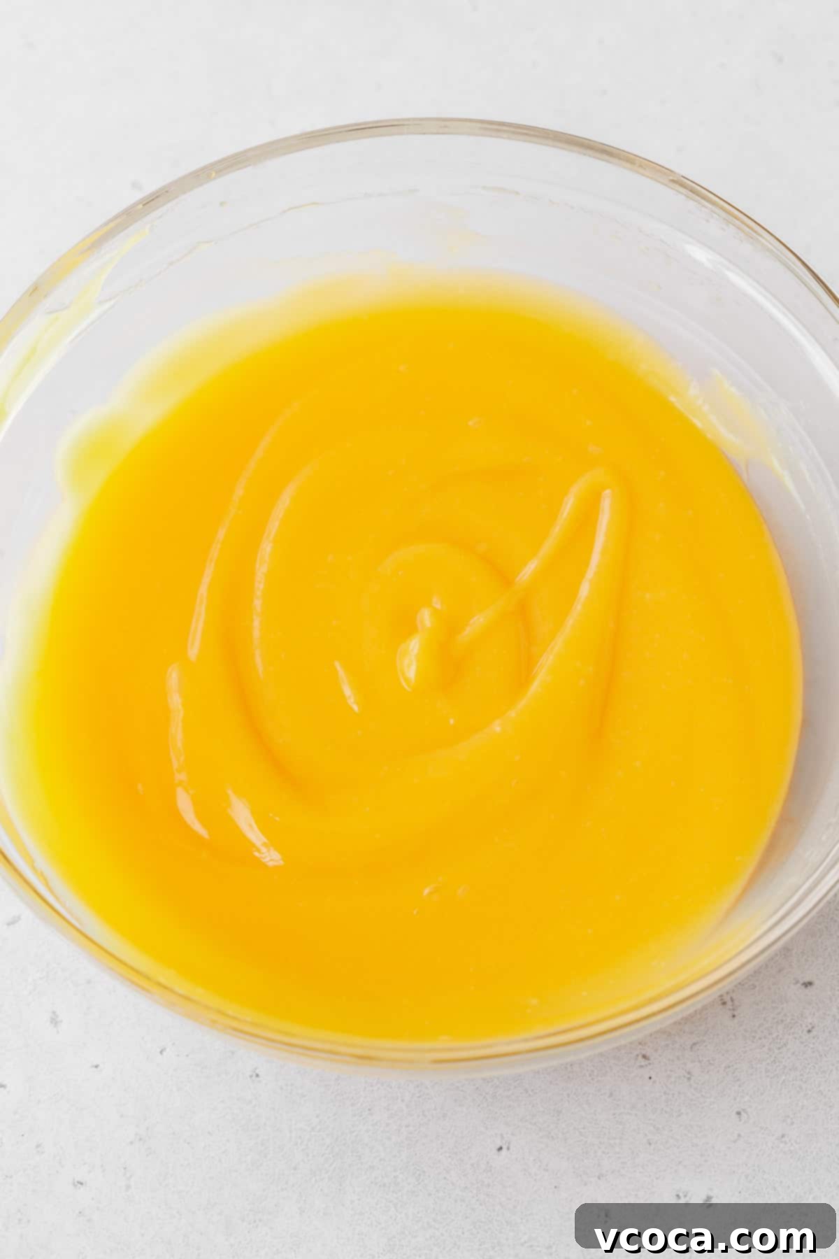 Bright and Zesty Dairy Free Lemon Bars 17 The smooth and silky lemon curd filling whisked up in a glass mixing bowl.