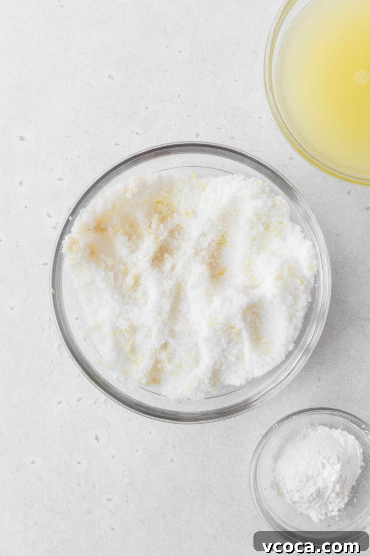 Bright and Zesty Dairy Free Lemon Bars 10 A glass mixing bowl of sugar and lemon zest being rubbed together.