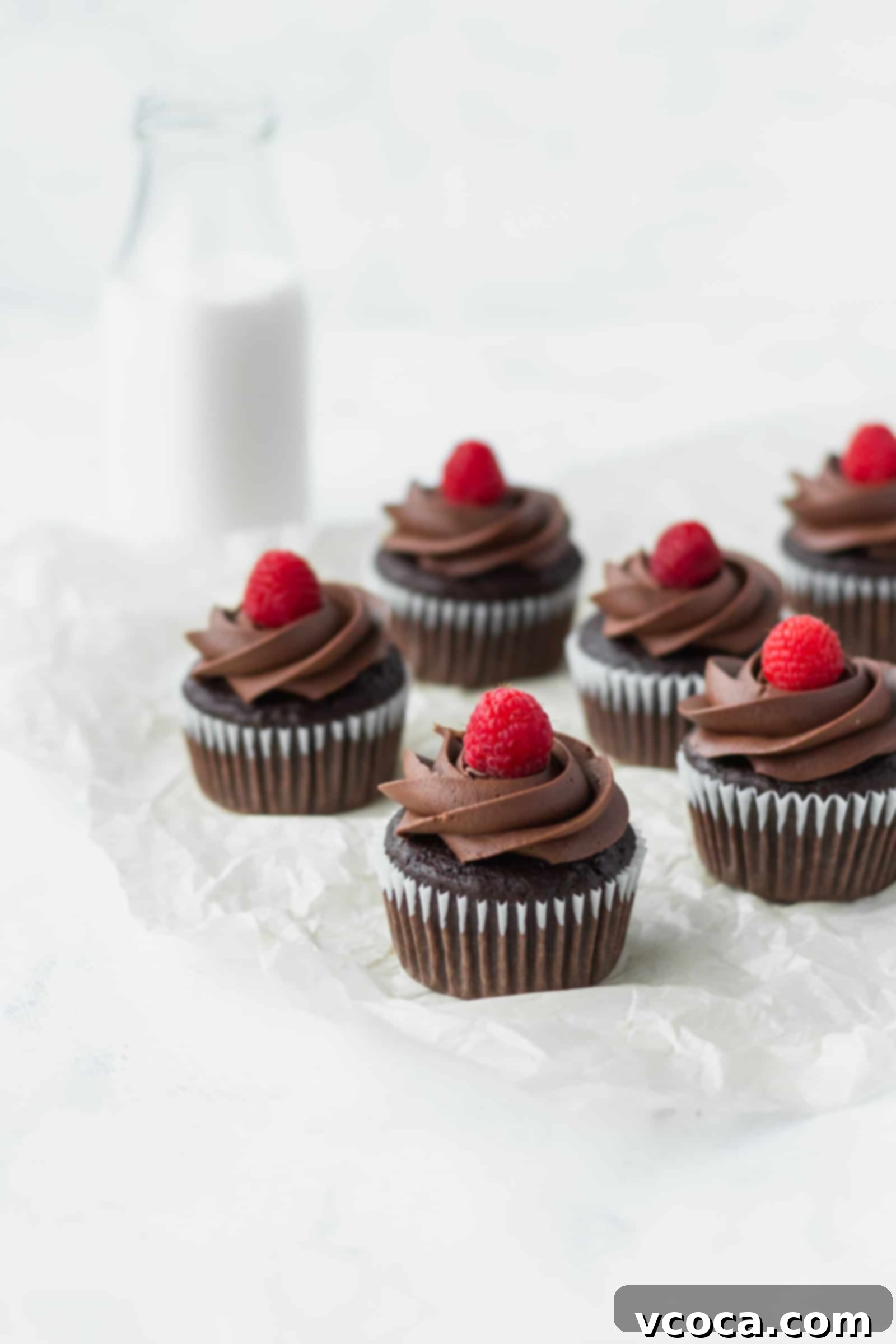 Decadent Vegan Chocolate Banana Cupcakes 2 Delicious and moist vegan chocolate banana cupcakes topped with creamy vegan chocolate buttercream and fresh raspberries, perfect for Valentine's Day.