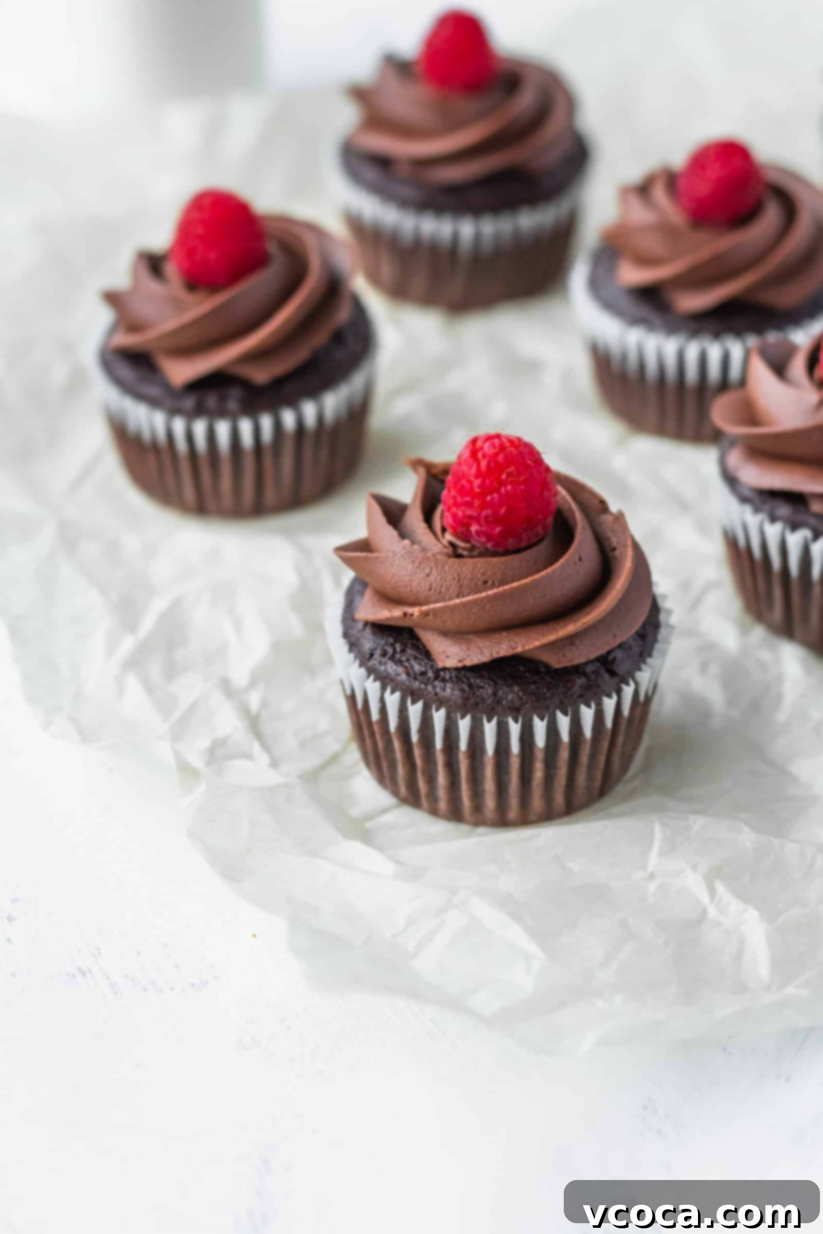 Decadent Vegan Chocolate Banana Cupcakes 3 Perfectly frosted vegan chocolate banana cupcakes, beautifully arranged for a Valentine's Day celebration.