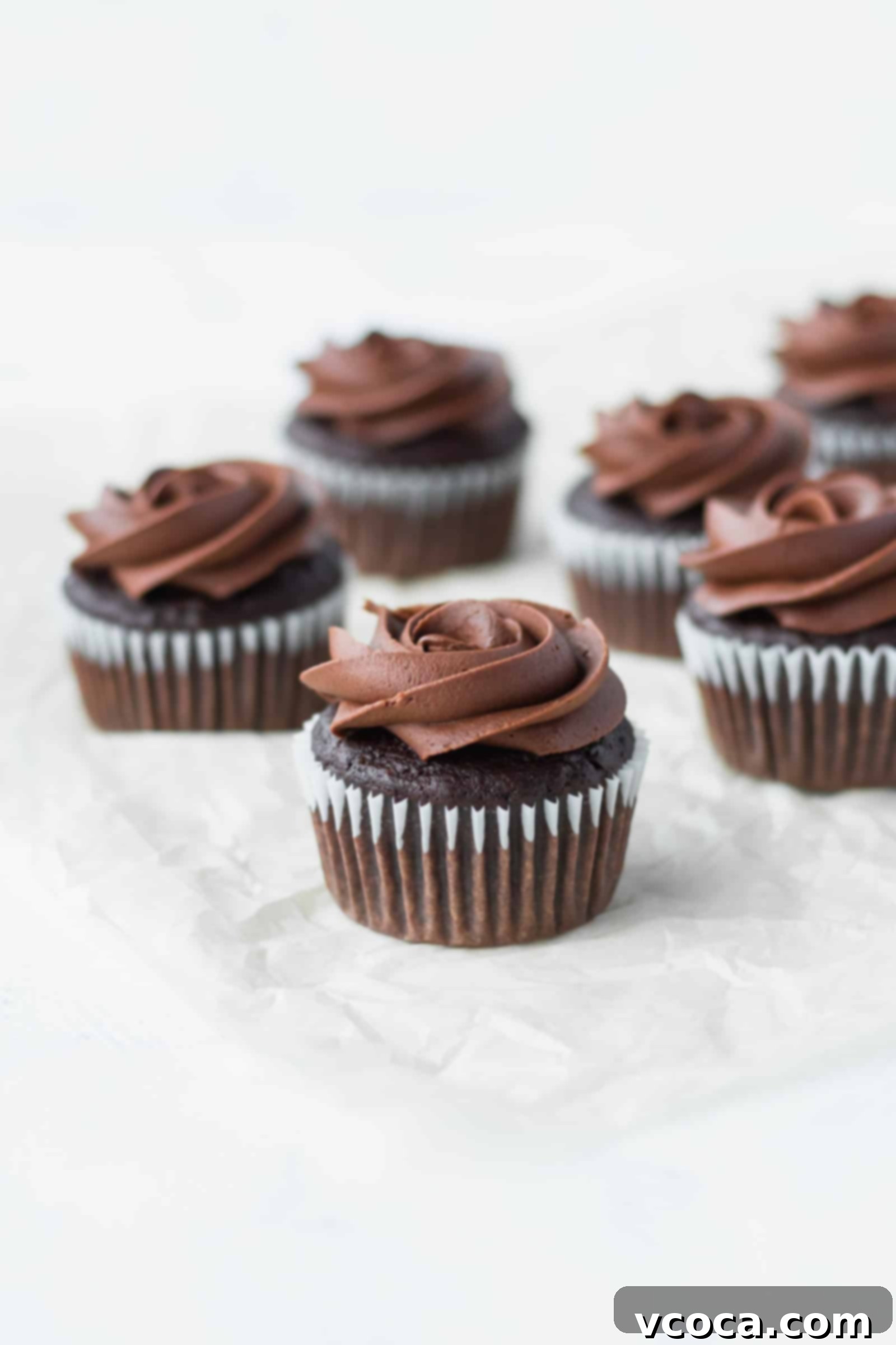Decadent Vegan Chocolate Banana Cupcakes 4 Freshly baked vegan chocolate banana cupcakes cooling on a wire rack, ready for frosting.