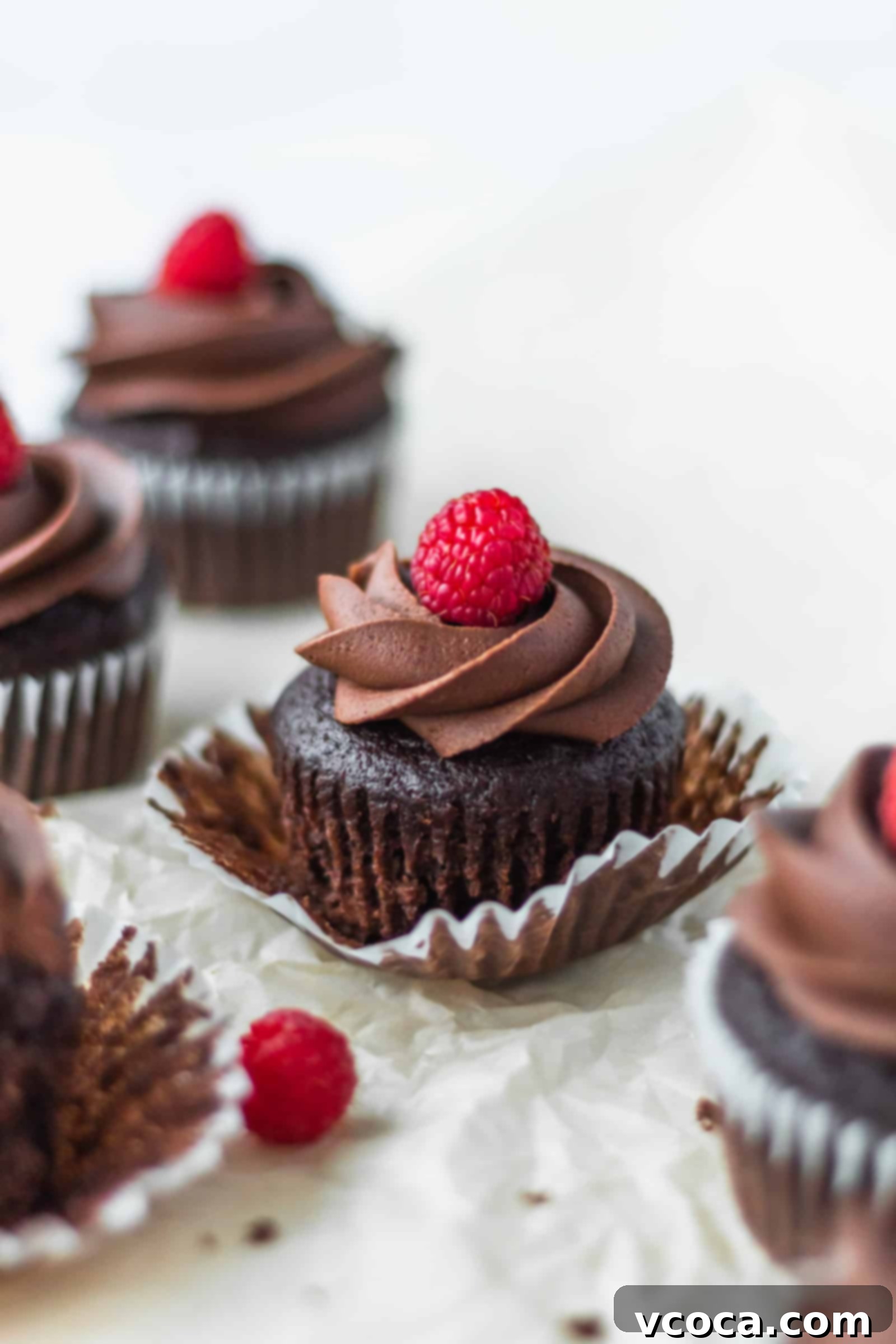 Decadent Vegan Chocolate Banana Cupcakes 5 Rich vegan chocolate buttercream being piped onto a cooled vegan chocolate banana cupcake, ready for garnish.