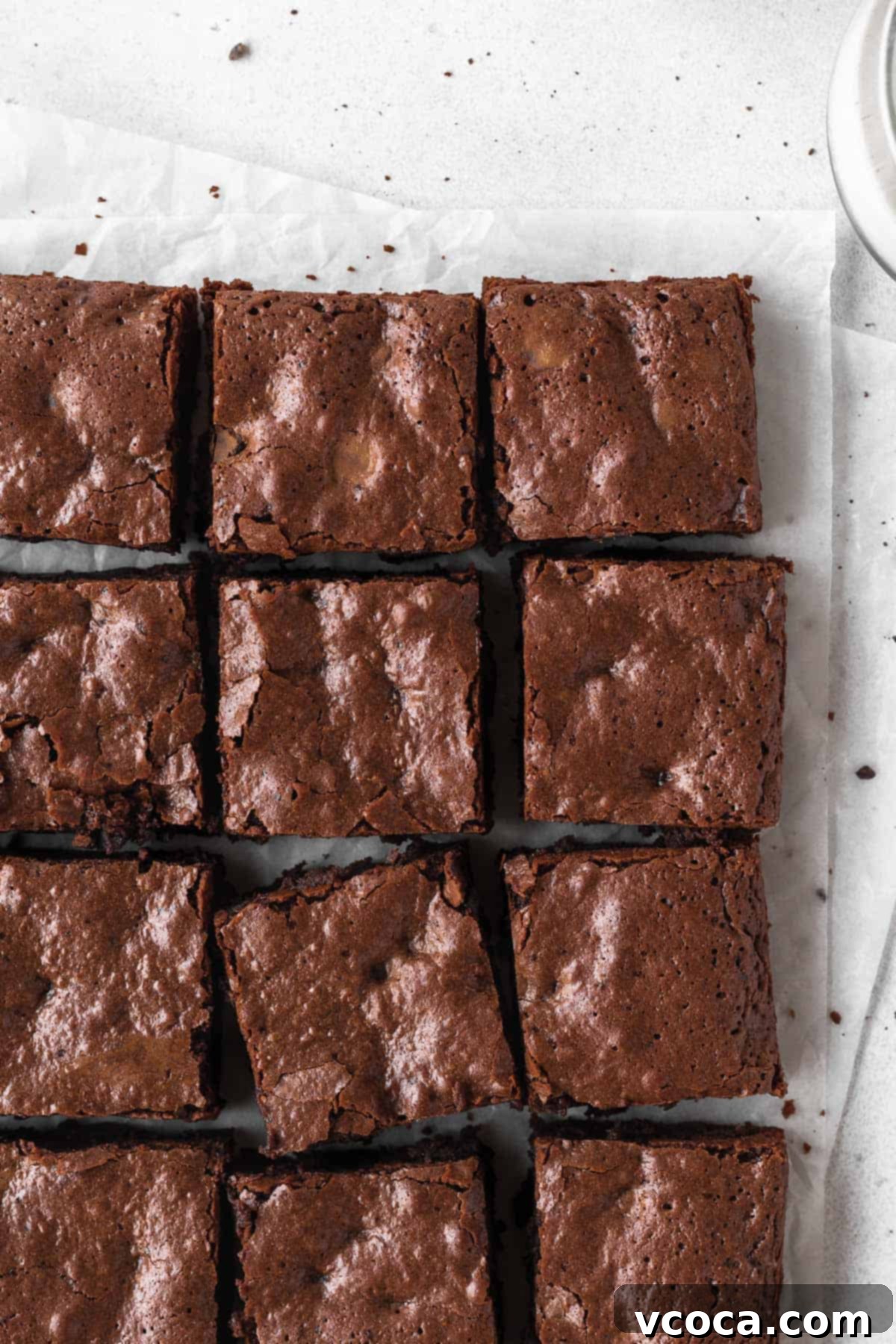 27 Reader-Favorite Gluten-Free Dairy-Free Treats 11 An overhead shot of a pan of sliced brownies on parchment paper.