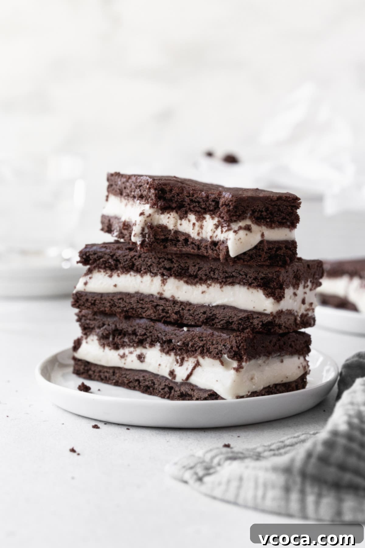 27 Reader-Favorite Gluten-Free Dairy-Free Treats 18 A stack of ice cream sandwich cookies on a small white dish with a large bite taken out of one of the cookies.