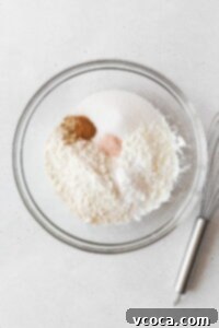 The dry ingredients for gluten-free pineapple upside down cake in a mixing bowl.