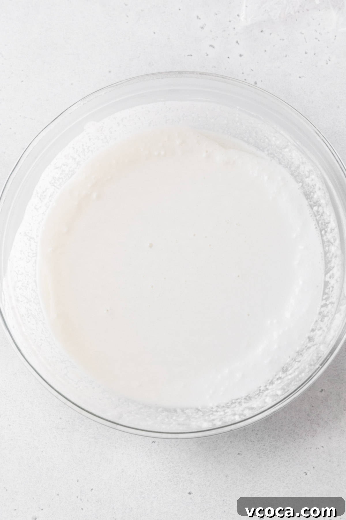 The daifuku batter, having undergone its first minute in the microwave, is now visibly thicker and slightly translucent in a glass bowl.