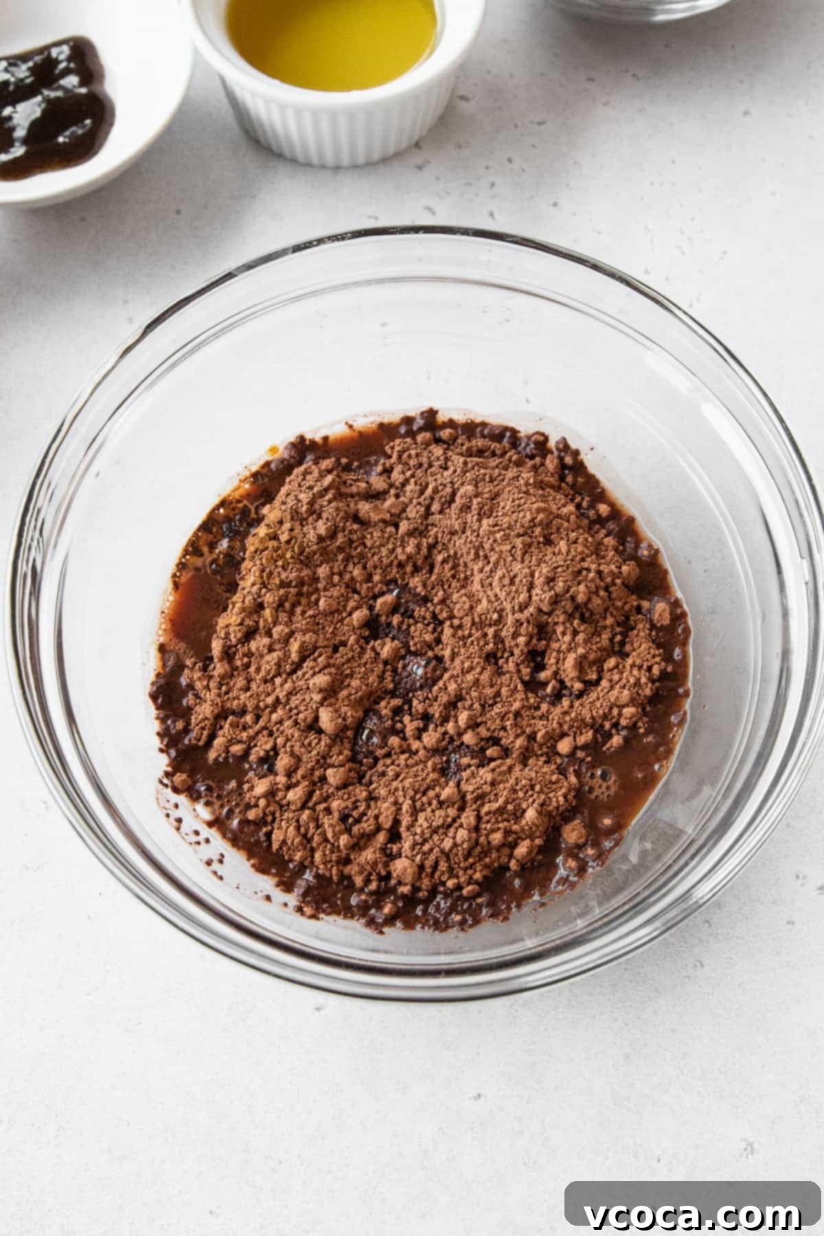 Velvety Chocolate Cupcakes 5 Cocoa powder being bloomed in a glass bowl with hot water.