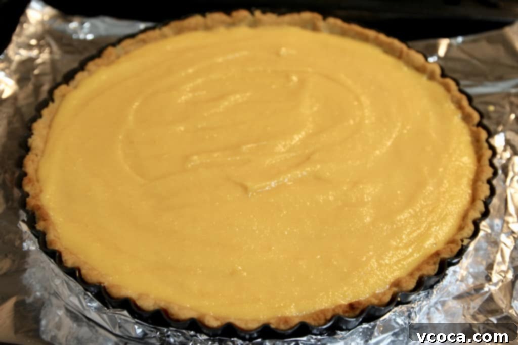 Zesty Grapefruit Tart 5 Grapefruit curd poured into a cooled tart shell, ready for chilling.