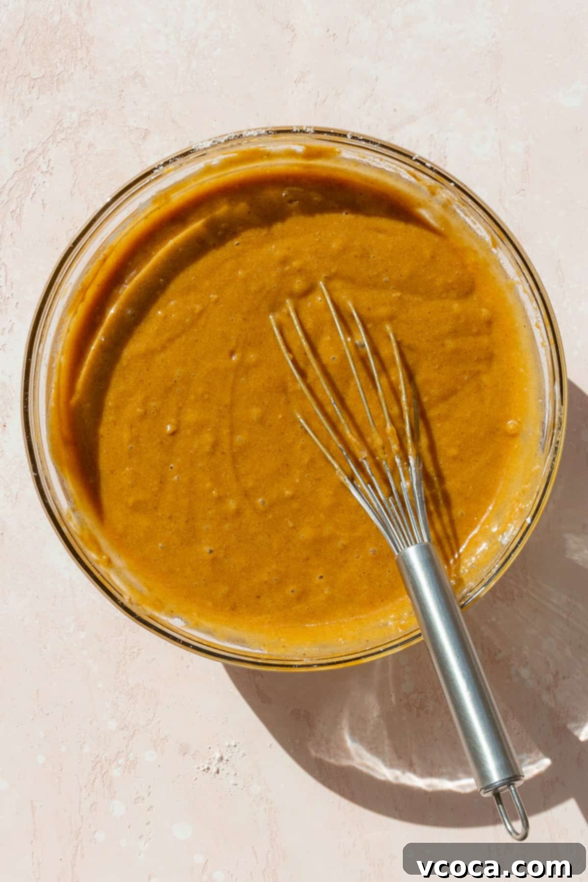Spiced Pumpkin Squares 8 Smooth, perfectly mixed pumpkin bar batter in a bowl with a wire whisk, ready for baking.