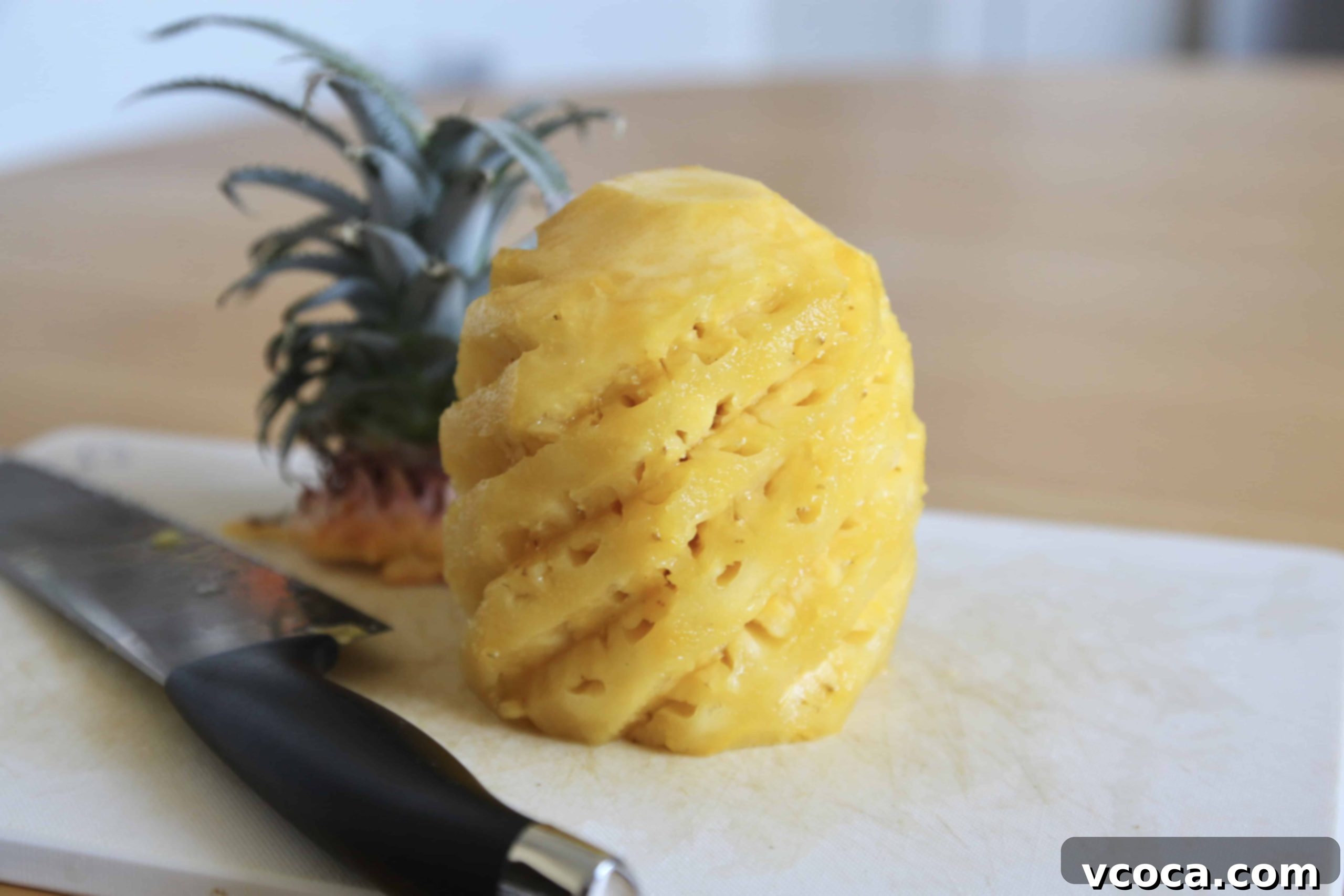 Tropical Piña Colada Swirls 4 A freshly peeled pineapple, with a knife indicating preparation, ready for chopping