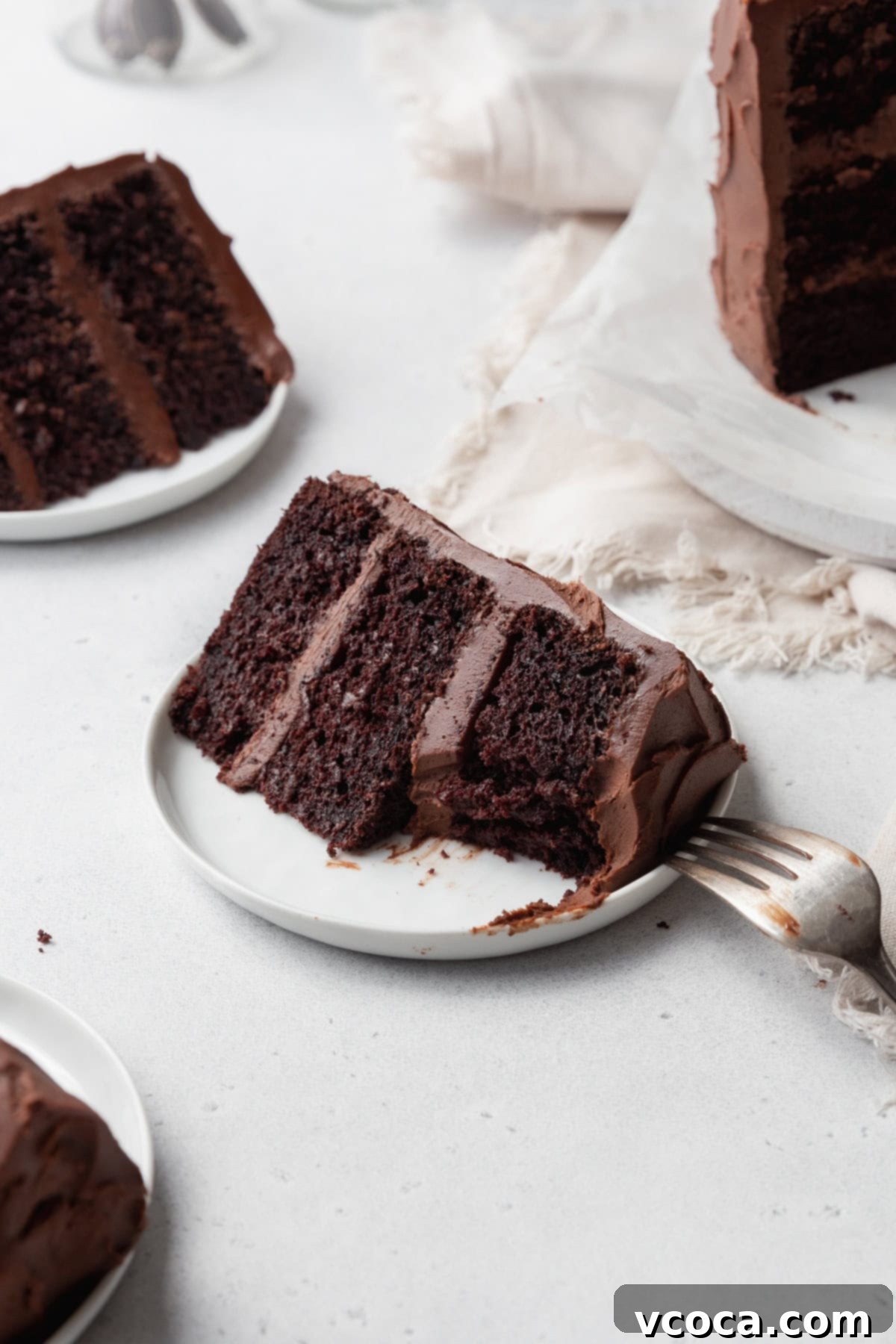 A slice of gluten free chocolate cake with a bite taken out.