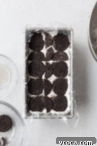 Chocolate cookies on top of cream to build an icebox cake.