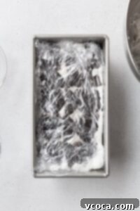 Ice box cake wrapped in plastic, ready to be chilled.