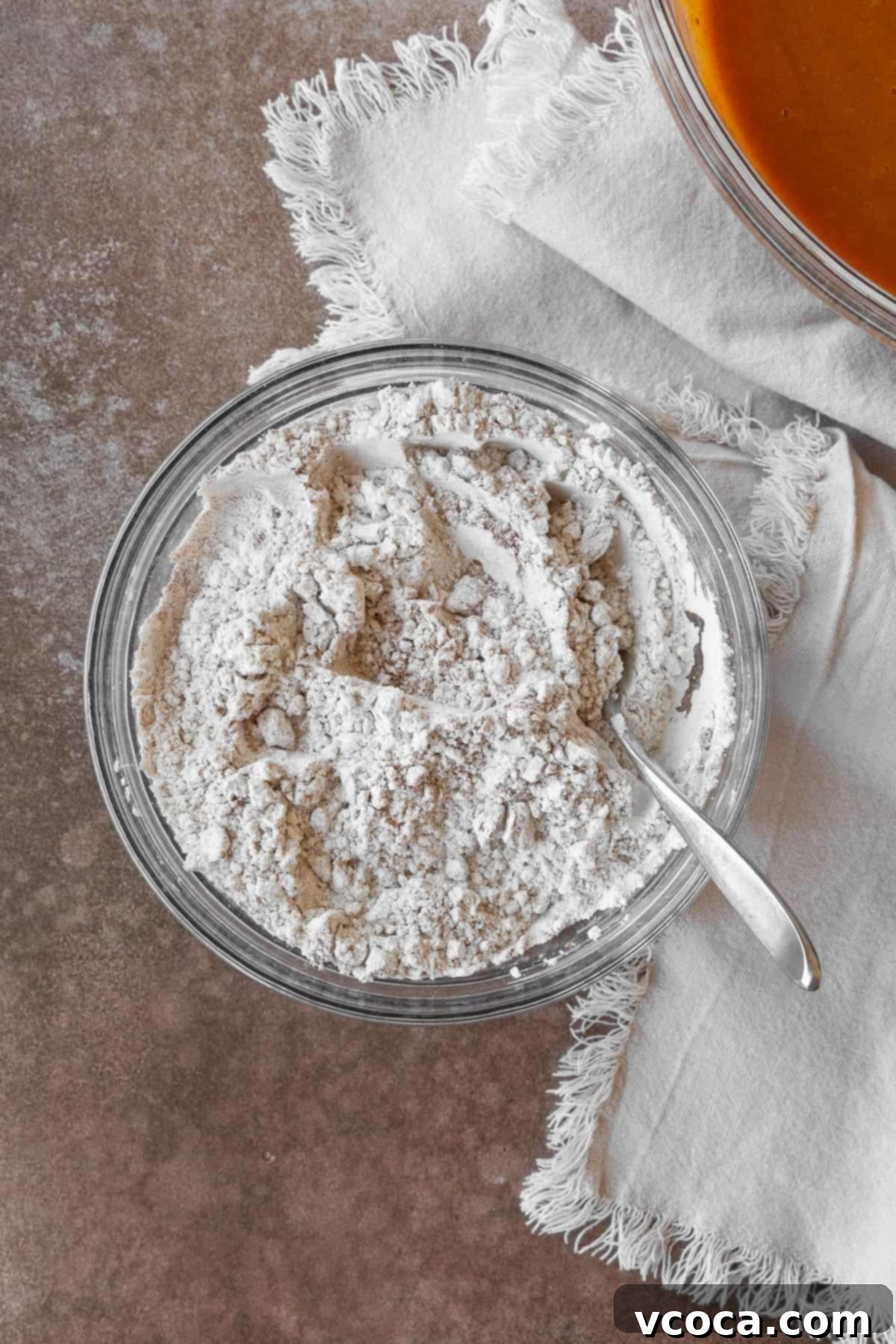 A bowl of flour and spices in a glass bowl.