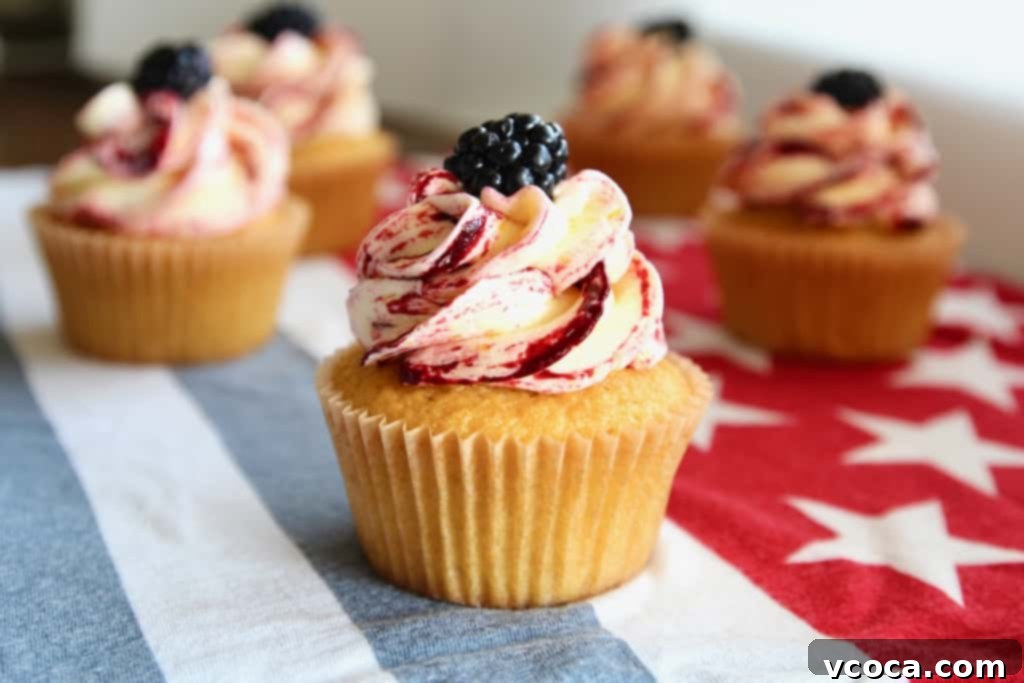 Sweet Corn Cupcakes with Blackberry Corn Frosting 5 Close-up of a corn cupcake revealing the fluffy texture and the beautiful swirl of corn and blackberry frosting.