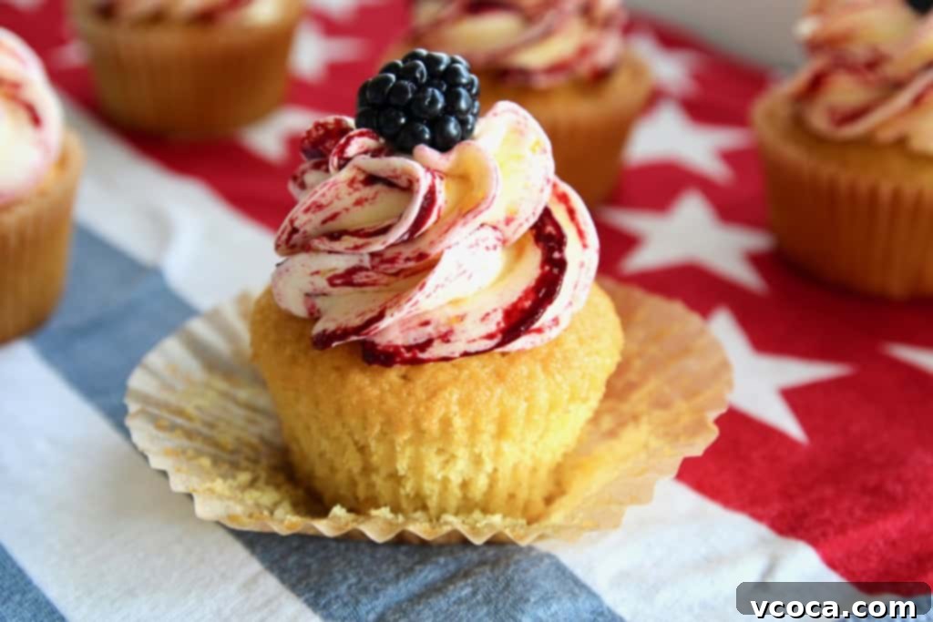 Sweet Corn Cupcakes with Blackberry Corn Frosting 6 A tray of beautifully decorated fresh corn cupcakes with corn and blackberry swirl frosting, ready to be served.