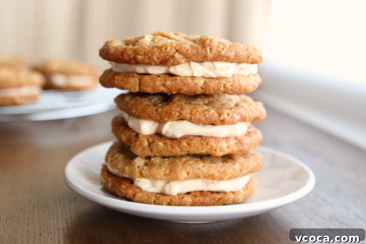 Scrumptious Chewy Coconut Oatmeal Cookie Sandwiches 2 A stack of oatmeal cream pie cookies on a small dessert plate.