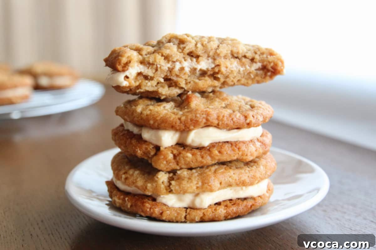Scrumptious Chewy Coconut Oatmeal Cookie Sandwiches 5 A stack of oatmeal cream pies with a bitten oatmeal cookie sandwich on top.