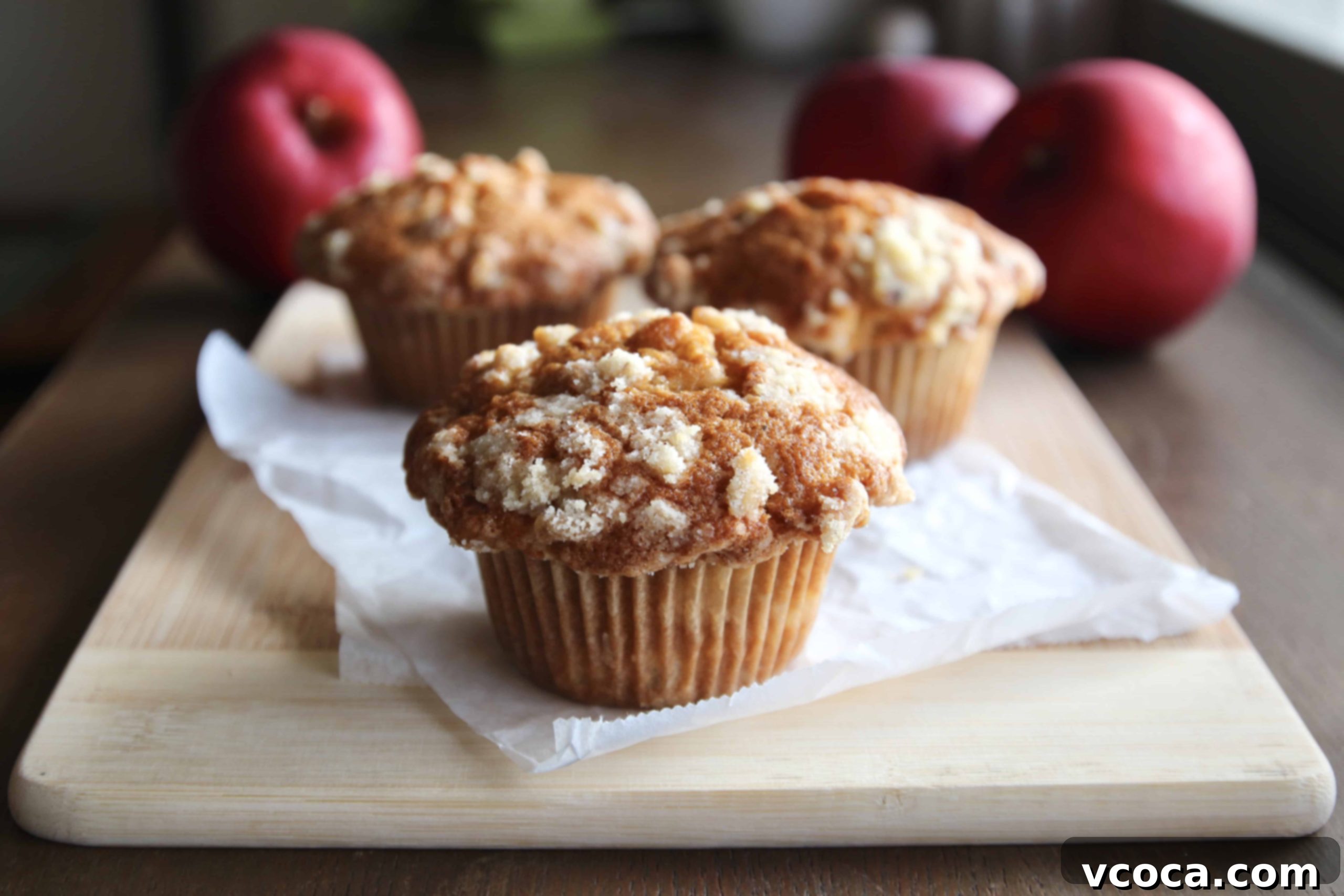 Apple Streusel Muffins 2 Apple streusel muffins on a wooden board