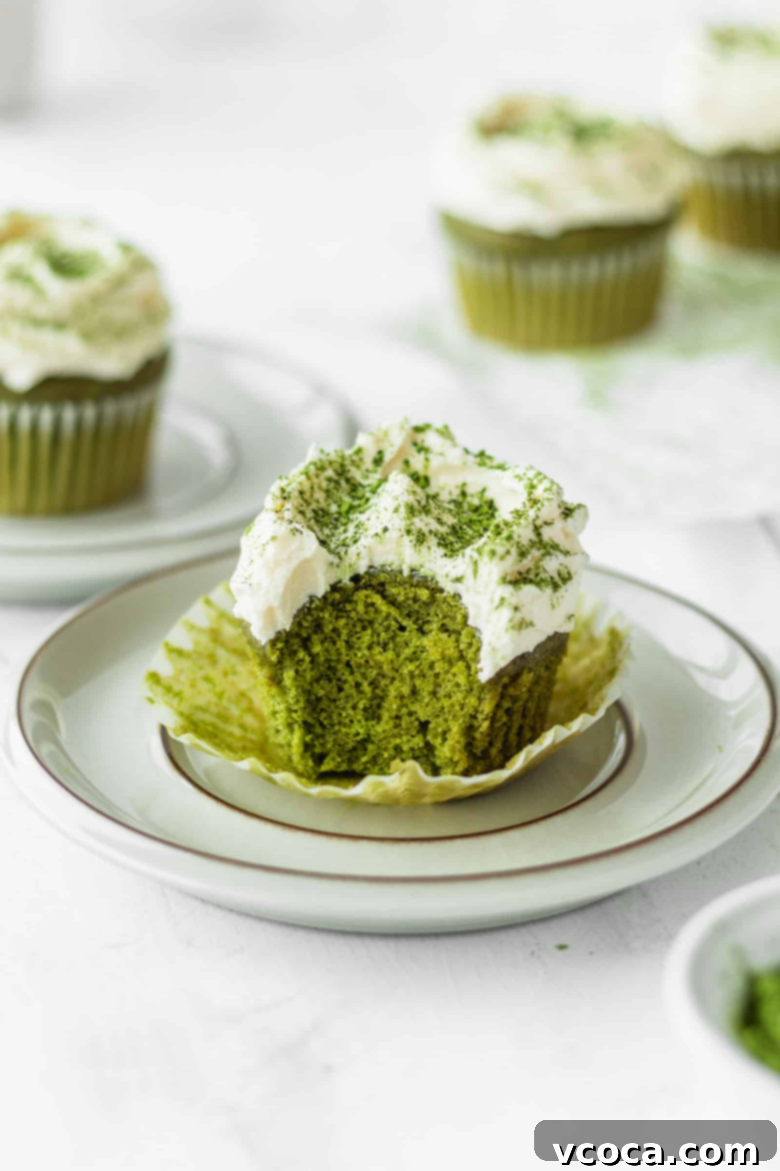 Fluffy green tea cupcake with a bite taken out
