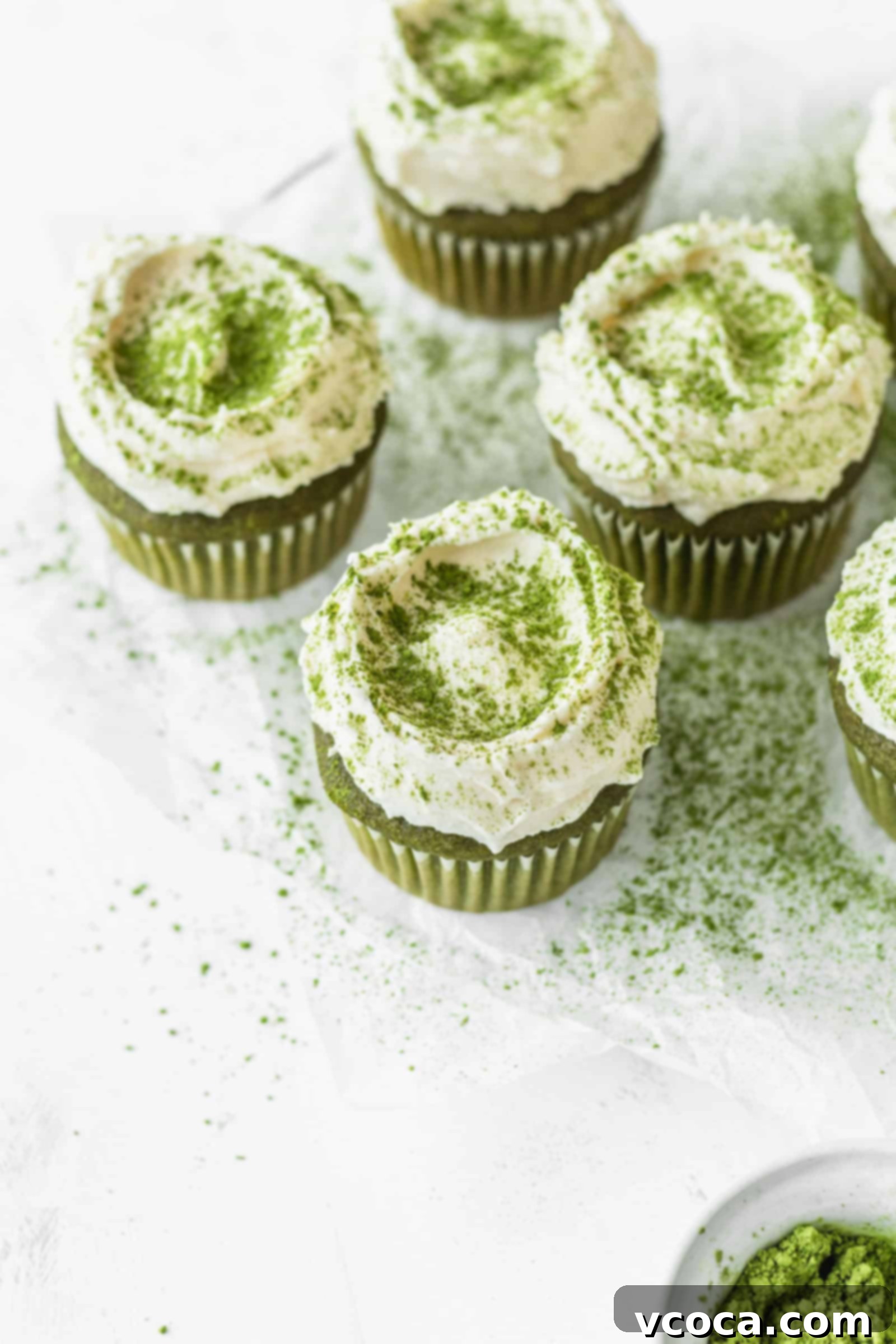 Fluffy white chocolate frosting on matcha green tea cupcakes
