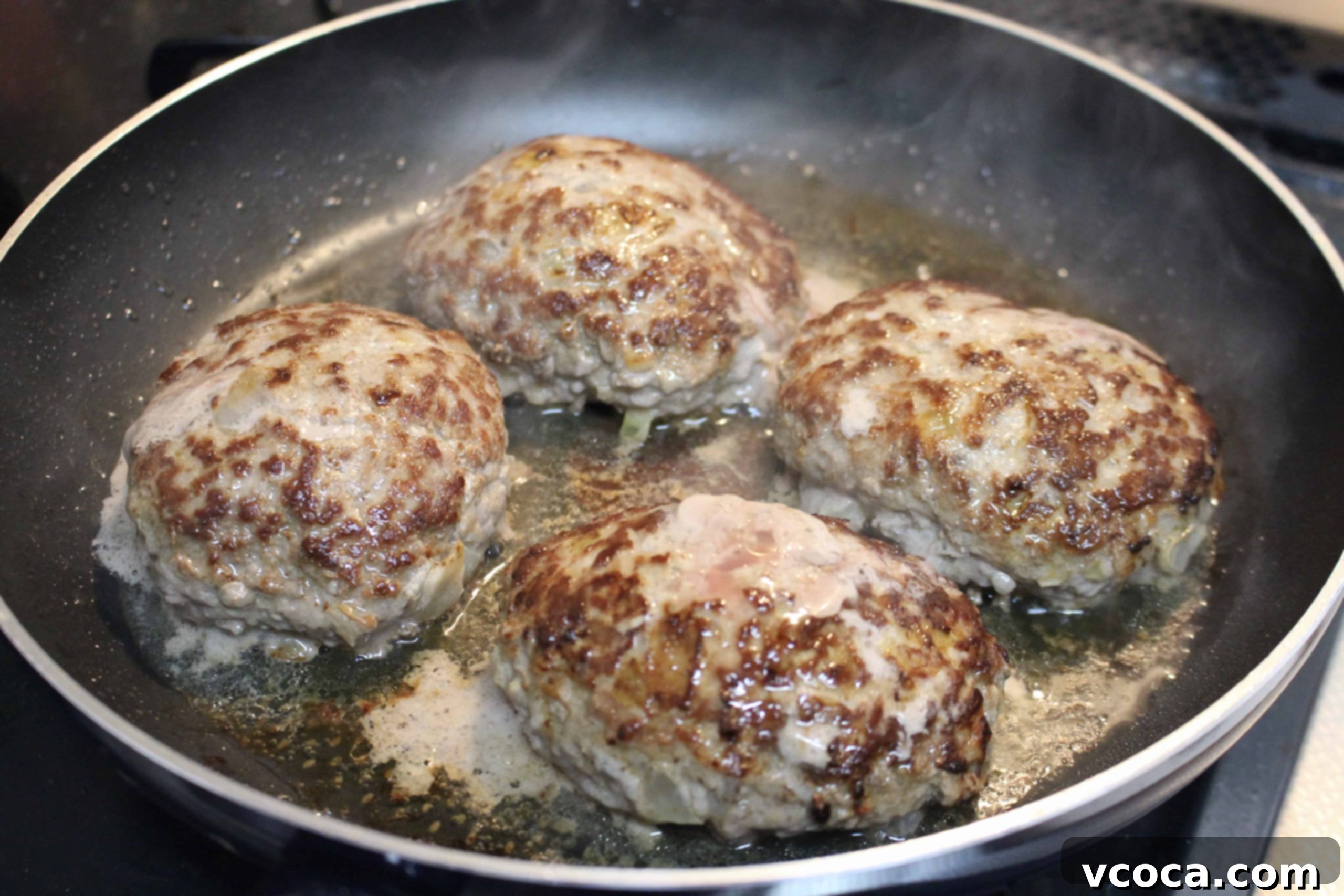 Creamy Mushroom Salisbury Steak 7 Salisbury steak patties searing in a non-stick pan