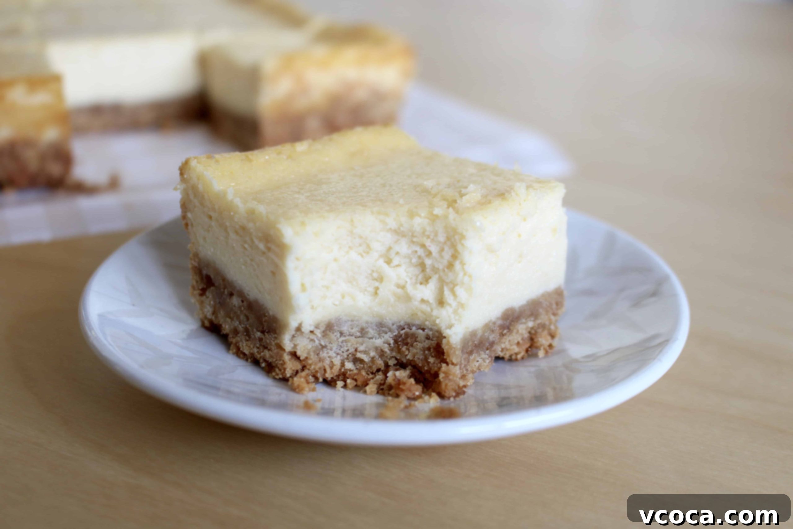 Deliciously creamy homemade cheesecake bars cut into perfect squares
